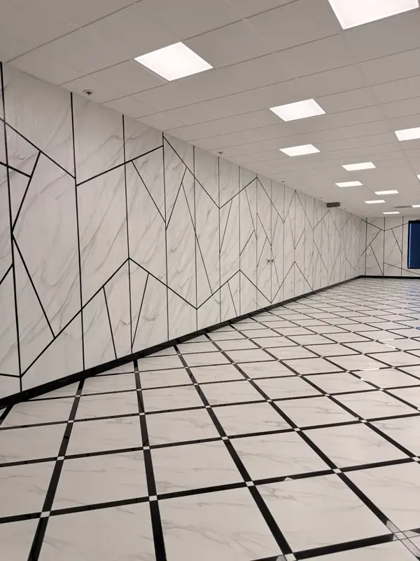Detail of the marble wall panels meeting the geometric floor
